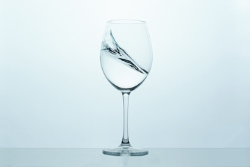 frozen movement of water in a glass on a blue-white background