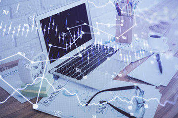Financial graph colorful drawing and table with computer on background. Double exposure. Concept of international markets.