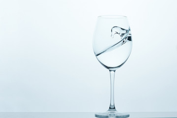frozen movement of water in a glass on a blue-white background