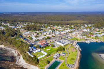 Aerial drone view of Huskisson on the New South Wales South Coast, Australia, showing Jervis Bay and the town centre on a bright sunny day   