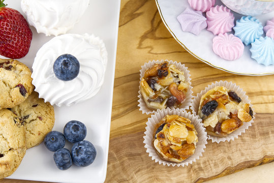 Oat cookies with Strawberry and bize cookies with blueberry on olive wood board