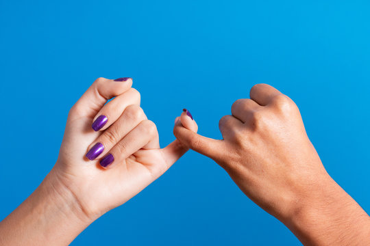 Women holding hands with fingers symbol of unity against gender crimes