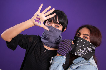 Covered face Latin girls protesting against gender injustice