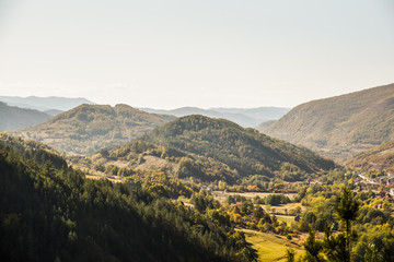 Fototapeta premium View over the beautiful lush landscape of Mokra Gora near the Zlatibor mountain in central Serbia during autumn taken from the resting spot of Sargan eight train station and tourist attraction