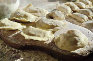 Dumplings, ravioli with cheese are on the kitchen table