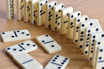 Playing dominoes on a wooden table. Dominoes game concept.