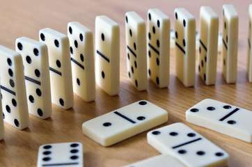 Playing dominoes on a wooden table. Dominoes game concept.