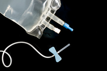 IV Bag And Blue Catheter On Black
