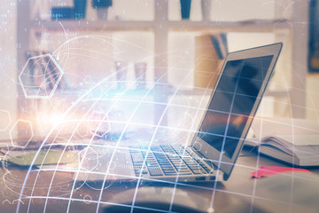 Multi exposure of table with computer and world map hologram. International data network concept.