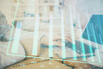 Multi exposure of stock market chart with man working on computer on background. Concept of...