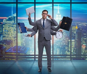 Young businessman in multitasking concept
