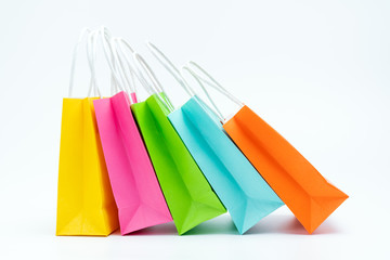 Colorful shopping bags standing in a row isolated on white background