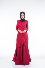 Naklejka premium Beautiful female Asian model in various poses wearing a red Malaysian traditional wear isolated on white background. Beauty and fashion concept. Full length portrait