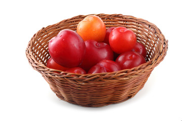 Plums on wicker plate
