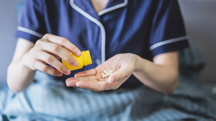 Bedridden woman is taking medicine 