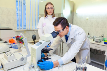 A group of scientists conducts research in a scientific laboratory using advanced technology
