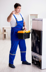 Repairman contractor repairing fridge in DIY concept