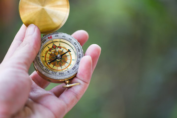 Man explorer searching direction with compass for map - Navigational compass travel and tourist concept