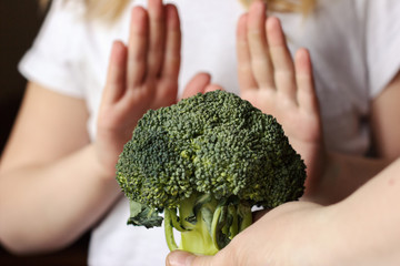 Healthy Green Organic Raw Broccoli. child rejecting to eat broccoli. children healthy eating...