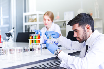 Team of scientist research working together conduct experiments in modern laboratory - Female and Male Scientists or doctor in lab biochemistry genetics forensics microbiology and test tube