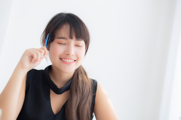 Naklejka premium Beautiful asian woman writer thinking idea and writing on notebook or diary with happy on desk office, lifestyle of asia girl is success, female planning working, education and business concept.