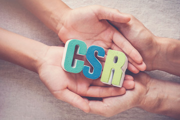 Hands holding CSR corporate social responsibility, business concept