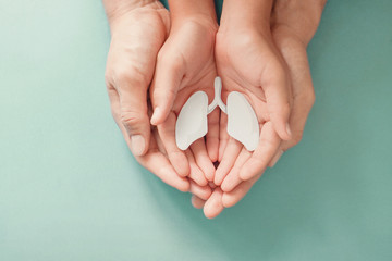 Adult and child hands holding lung, world tuberculosis TB day, lung cancer, copd, respiratory...
