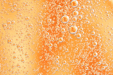 Yellow and orange bubbles, drops of oil in water