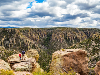 two people taking in view of hoodoos from top of Chiricahua National Monument