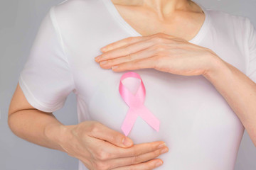 World Breast Cancer Day Concept,health care - woman wore white t-shirt,Pink ribbon for breast...