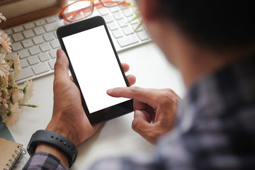 Cropped shot view of man hands holding smart phone with blank copy space screen for your text message or information content, female reading text message on cell telephone during in urban setting. 