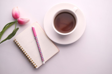 top view of tea, notepad, flower for morning breakfast 