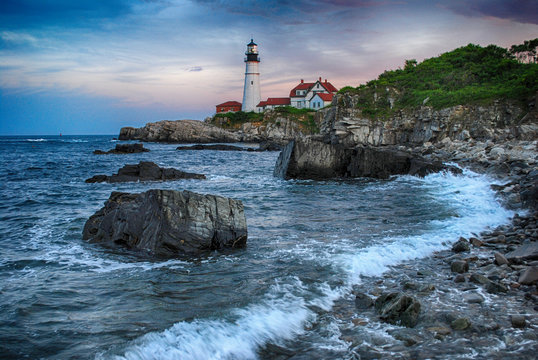 Portland gead Lighthouse in Cape Elizabeth on a sunset, accompanied by breaking waves, dramatic in colour