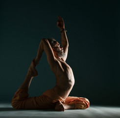 Old man with grey beard doing yoga, pilates, fitness training, stretching exercise, asana or...