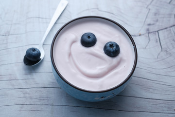 Close up of berry fruit on yogurt, happy fruit funny face 