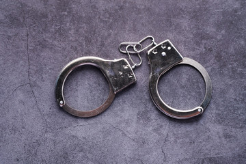 top view of handcuff on black background, crime concept 