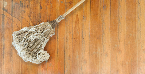 Housework background with broom on wooden floor