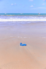 Fototapeta na wymiar blue trash bag thrown on the beach, plastic bag thrown into the sea, World environment day