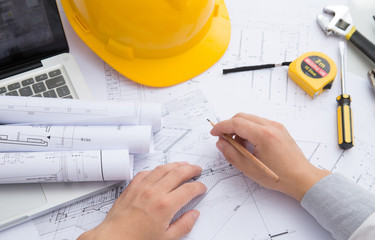 Yellow hard hat tools and drawings