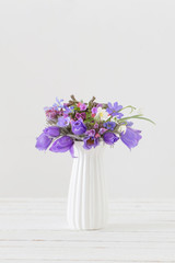 bouquet of spring violet flowers on white background
