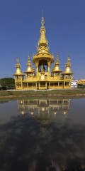 Gold Yellow Temple Exterior Vertical Panorama in Famous Wat Rong Khun Buddhist Complex, Chiang Rai Province, Thailand