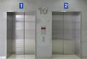 Closed metal elevator doors of office building. © zilvergolf