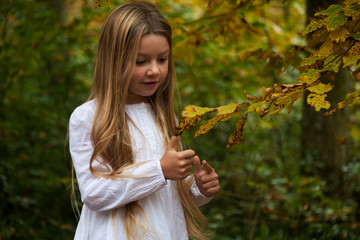 Young girl in the autumn forest