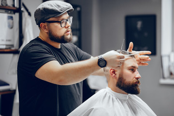 Hairdresser with a client. Man with a beard. Guy in a barbershop