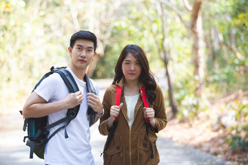 Happy asian couple adventure travel trip backpack hiking.
