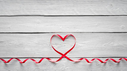Ribbon shaped heart on wooden background. Valentines day, Mothers Day, Happy Birthday, Wedding, Womens Day -Concept