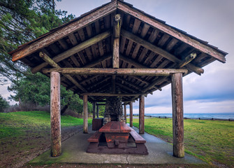 Barbecue (BBQ) hut with picnic table along the ocean