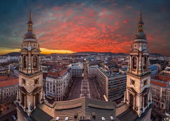 Foto op Plexiglas Budapest, Hungary - Amazing dramatic sunset over Budapest taken from the top of St.Stephen's Basilica. The view includes two towers of basilica, St.Stephen's Square, Buda Castle & Zrinyi street © zgphotography