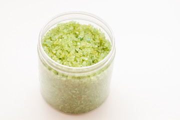 A green bath salts in a open jar. Body care cosmetic products