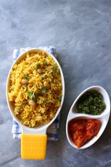 Indian comfort Food - Fresh Masala peanuts rice also known as Peanuts Pulav or rice khichdi. Garnished with coriander. Served hot with green chutney and mango pickle. with Copy space. 
